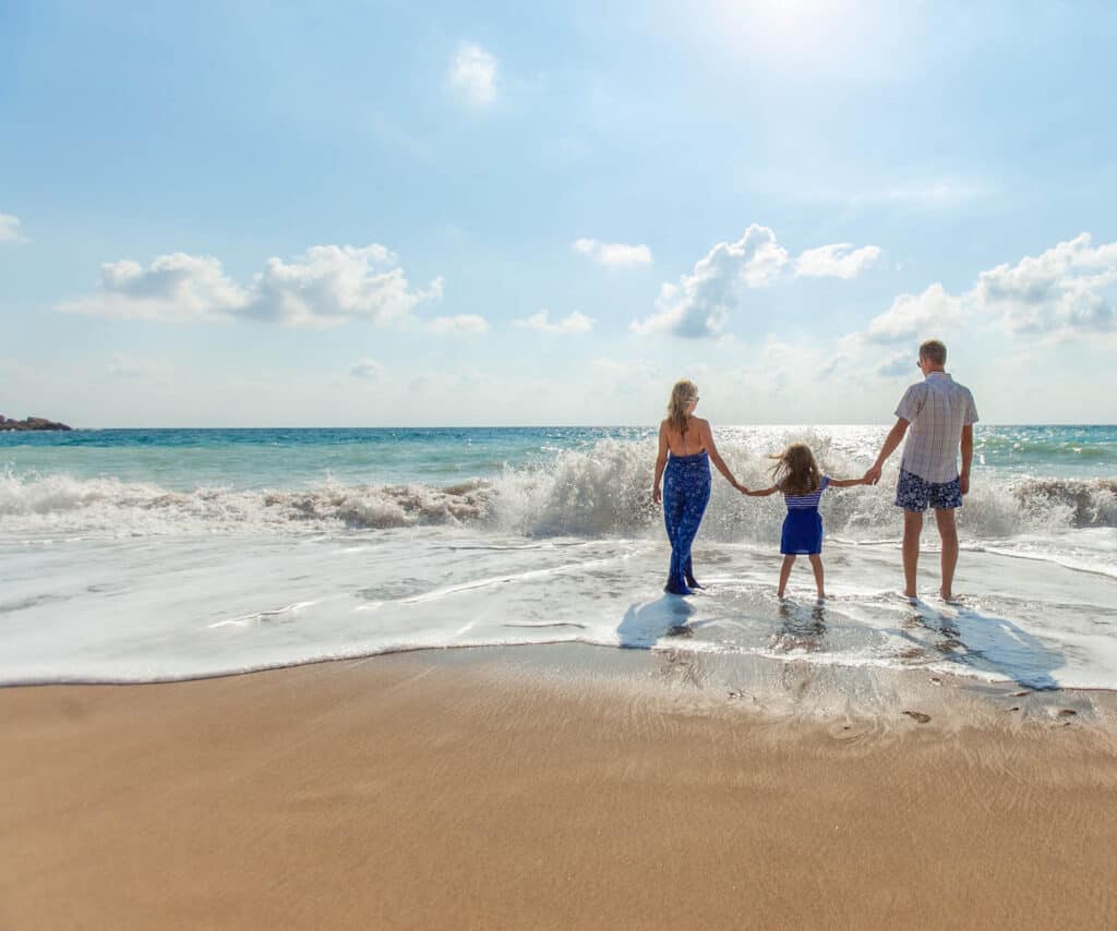 family walking on the beach